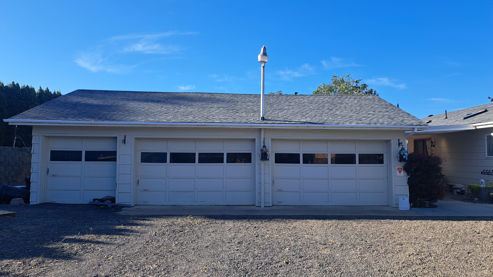 Completed residential roof with new architectural shingles over three-car garage